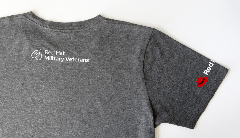 A t-shirt with the Red Hat Military veterans logo on the back and then Red Hat logo on the right sleeve.